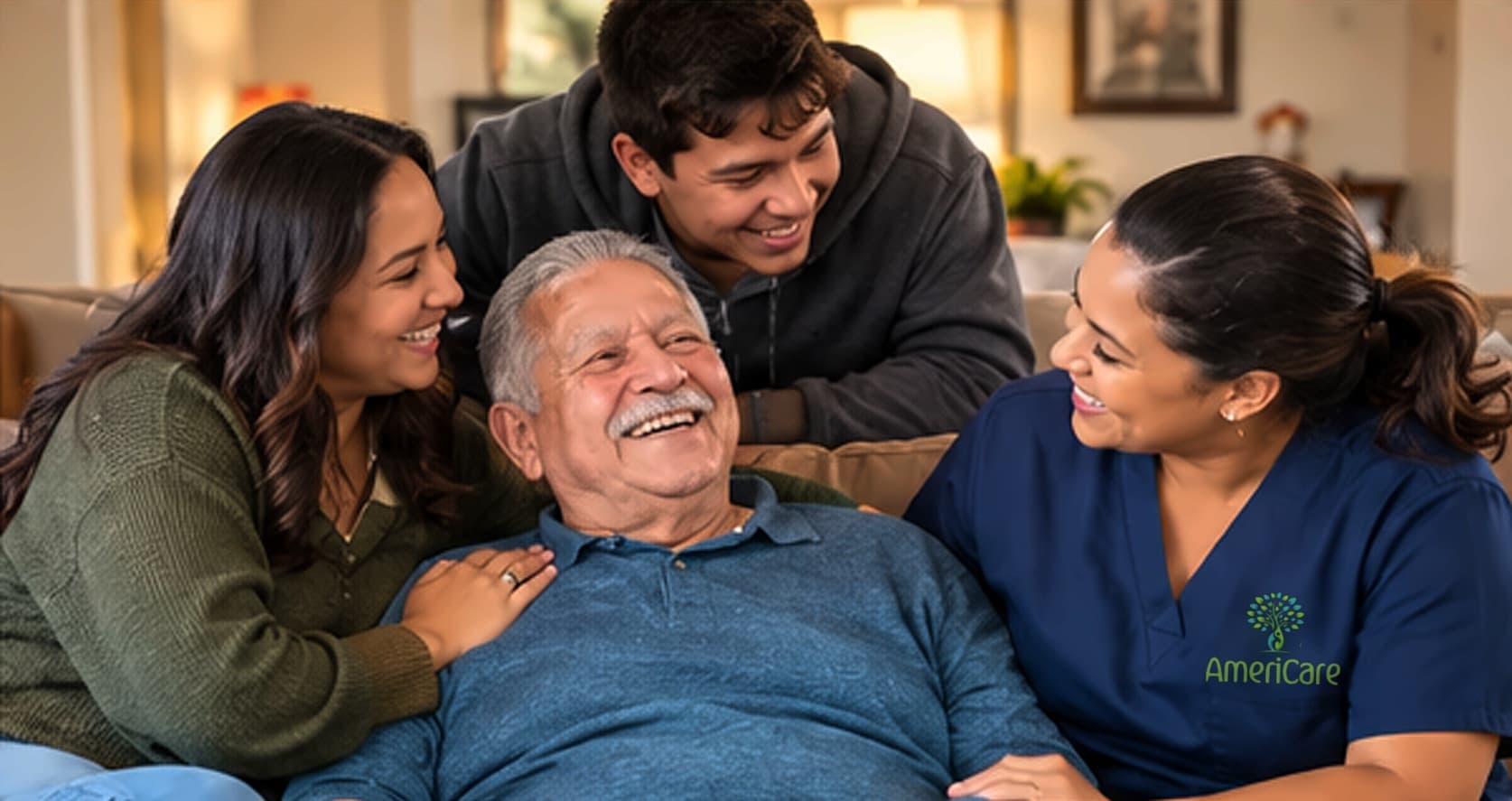 Senior man smiling with family and AmeriCare caregiver at home